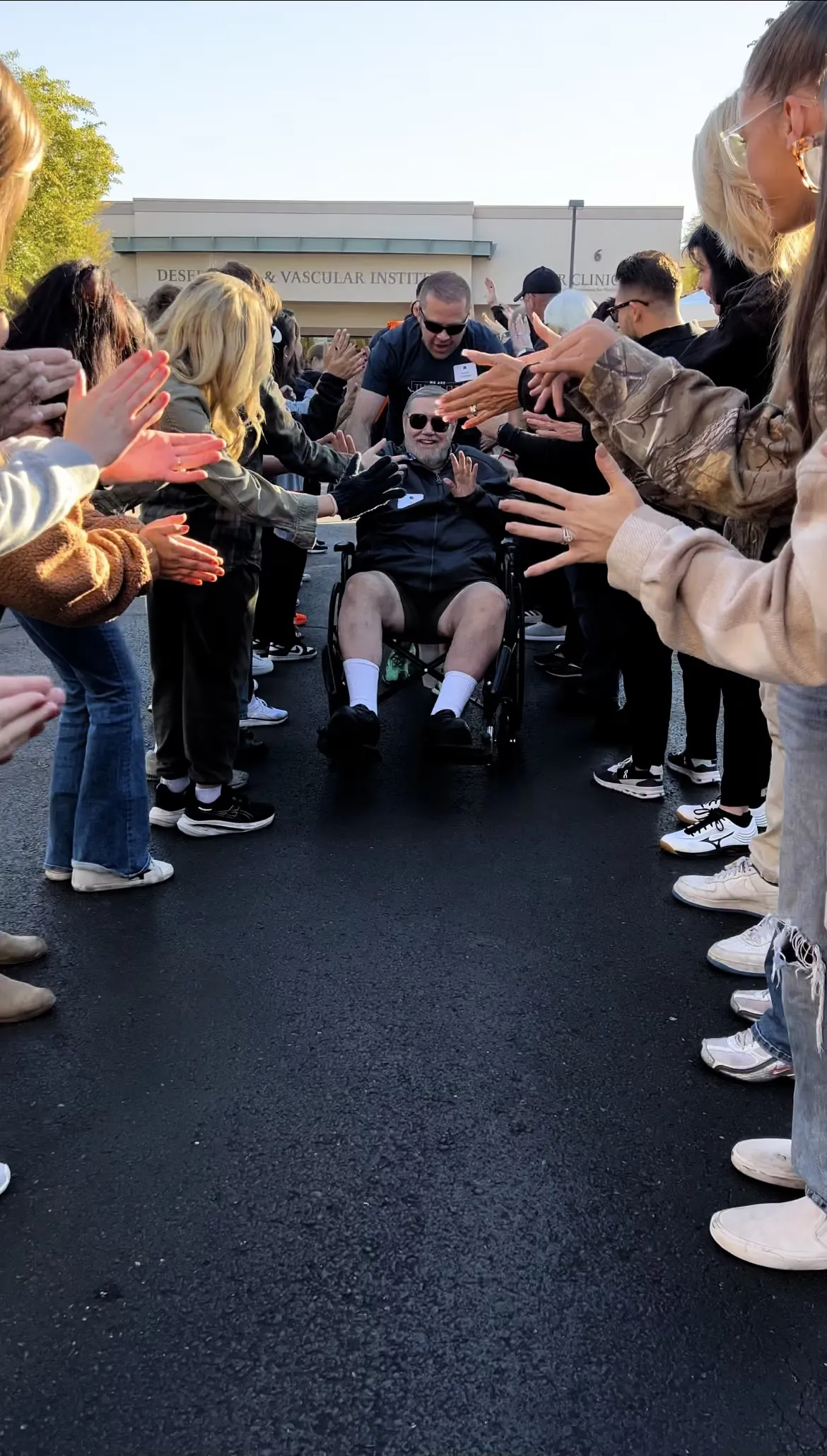 Guests walking through a high-five tunnel of cheering volunteers