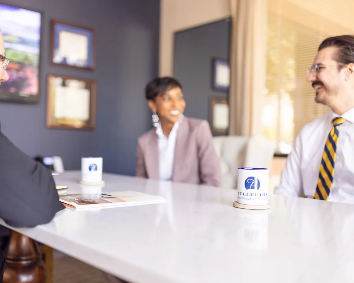 Fullerton advisors talking with a client across the conference table